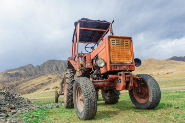 Obraz premium Lonely old tractor in Altai steppe in rainy day