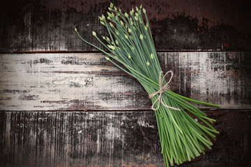 flowering chinese garlic chives on wooden table