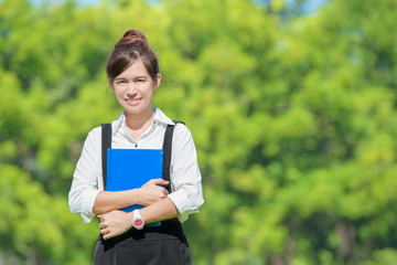 Fototapeta premium Asian student holding books on campus at college