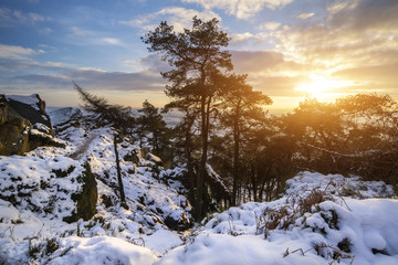 Stunning Winter sunset landscape from mountains looking over sno