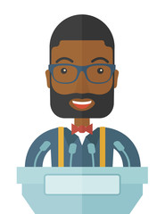  Black speaker stand behind a podium.