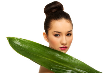 Beautiful woman with green leaf.