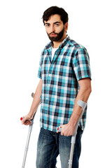Young disabled man with crutches.
