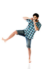 Young casual man kicking.