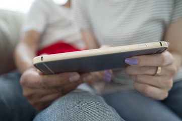 The couple are looking at a video together in a smartphone