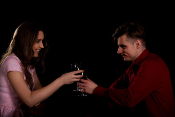 Couple with wine by a table.