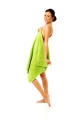 Happy woman wrapped in towel