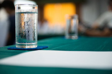 glass of cold water on table in meeting room