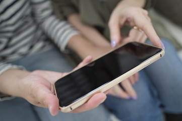 Women looking at smartphone together