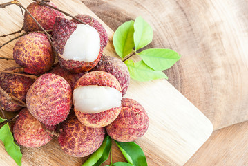 Closeup of lychee fruits on wooden board, fruits of asian