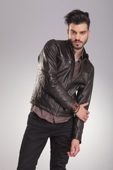 Fototapeta premium fashion man holding his right hand on his left elbow