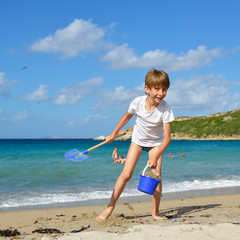 Child boy playing on the beach