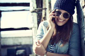 Girl having fun outdoors calling smart phone, lifestyle. Toned.