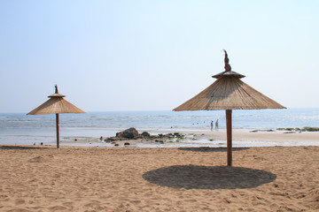 Grass umbrellas at the beach