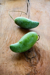 Green mango on old wooden table