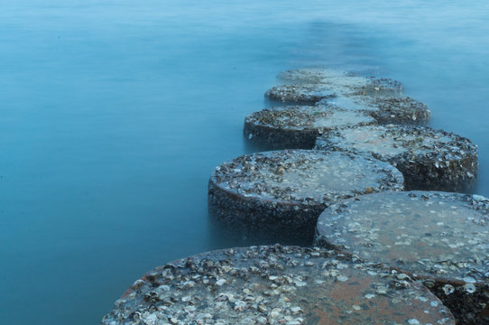 row of stones stepping on the sea