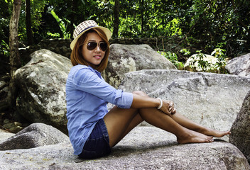 Thailand Asian woman sit on the rock