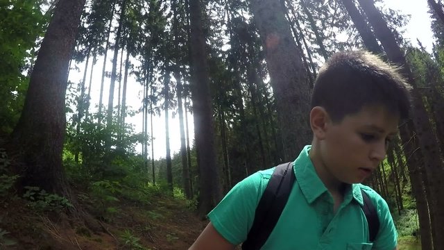 Teenager walking up on forest and taking selfie shot