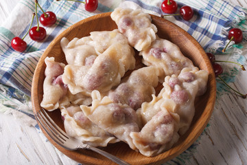 Homemade dumplings with fresh cherries horizontal top view
