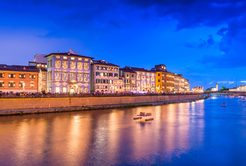 Fototapeta premium Pisa, Italy. Lungarno Gambacorti with illuminated city buildings