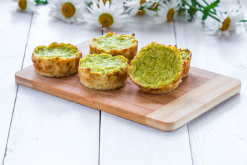 baked ruddy   fritters of zucchini on a bamboo board