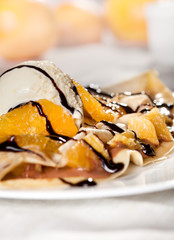 Crepes with vanilla ice cream and fruit - close up
