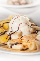 Crepes with vanilla ice cream and fruit - close up