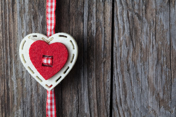 Red hearts hanging over old wood background