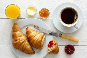 Coffee, orange juice and croissant breakfast. From above.