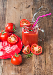 Fresh tomatoes and a glass of tomato juice
