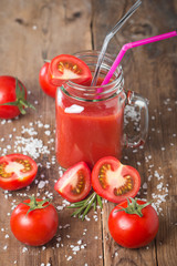 Fresh tomatoes and a glass of tomato juice