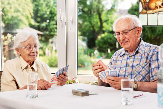 Elderly couple playing cards