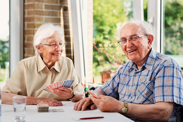 Elderly couple playing cards