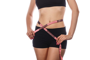 Slim woman measuring waist after diet.