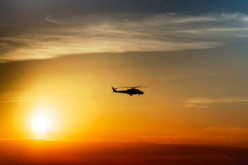 Fototapeta na wymiar silhouette combat helicopter against the sky