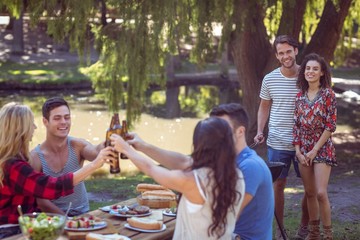 Happy friends in the park having lunch