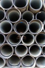 Black sewer pipes stacked, ready for undergrounding