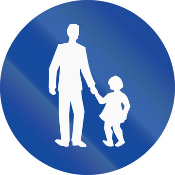 Greek sign at a pedestrian lane depicting father and child