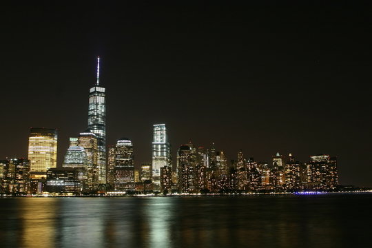 Fototapeta Manhattan night  view with skyscrapers  on the left