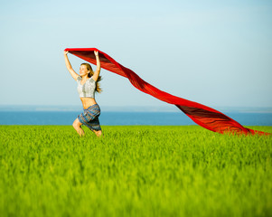 Young happy woman in wheat field with fabric. Summer lifestyle