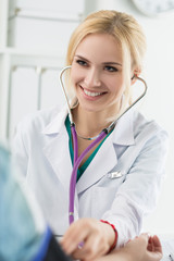 female medicine doctor measuring blood pressure