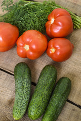 fresh vegetables, cucumbers, tomatoes and fennel on wooden background