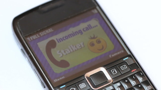 Stalker calling - Close up shot of a cellphone screen with incoming call from a stalker, before that screen shows 19 missed calls and 11 unread messages