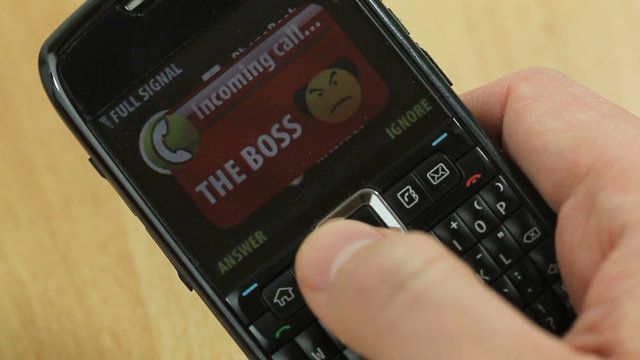 Ignoring the Boss #2 - Smartphone with incoming call from an angry boss getting ignored after picking up from the surface of the table
