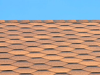 Bituminous tiles roof taken closeup.