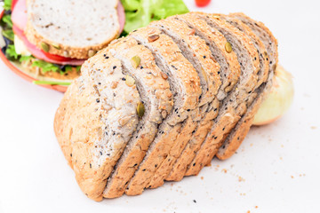 whole wheat bread and sandwiches in background