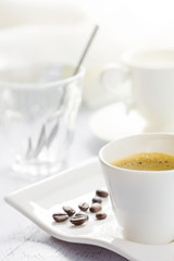 Cup of coffee on white wooden background