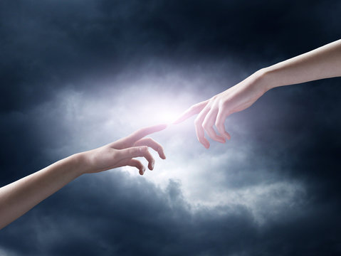 religion concept. finger touching the magic sky