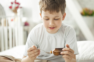 boy drinking cough syrup