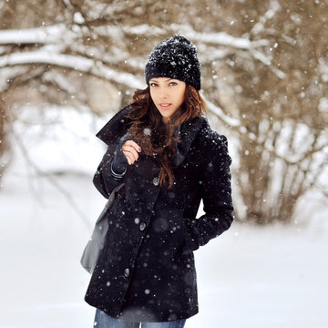 Portrait of a young beautiful woman in snowy weather